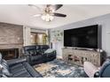 Living room view featuring a fireplace, media center, and leather reclining sofas at 8231 N 21St Dr # E101, Phoenix, AZ 85021