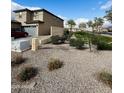 Side yard featuring rock landscaping, a block wall, and convenient garage access at 8420 S 40Th Dr, Laveen, AZ 85339