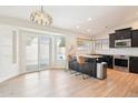 Modern kitchen featuring stainless steel appliances, a breakfast bar, and sliding door with pool view at 8562 W Windsor Blvd, Glendale, AZ 85305