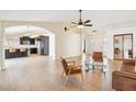 Spacious living room with hardwood floors, an archway into the kitchen, and stylish furnishings at 8562 W Windsor Blvd, Glendale, AZ 85305