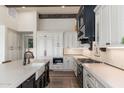 Modern kitchen design with white cabinetry, black accents, and a sleek stainless steel range and hood at 9565 E Mountain Spring Rd, Scottsdale, AZ 85255