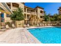Bright and inviting community pool with lounge chairs, surrounded by well-maintained apartment buildings at 10136 E Southern Ave # 3065, Mesa, AZ 85209