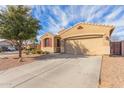 Inviting single-Gathering home featuring a two-car garage, desert landscaping, and a covered entrance at 1380 W Angus Rd, San Tan Valley, AZ 85143