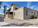 Beige stucco home featuring desert landscaping, brick accents and multiple stories under a bright, sunny sky at 14644 N Yerba Buena Way # C, Fountain Hills, AZ 85268