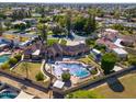 An aerial view shows a beautiful backyard with a large pool, manicured lawns, and landscaping at 1520 E Elmwood Cir, Mesa, AZ 85203