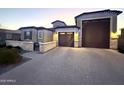 Attractive home with a paver driveway and a 3-car garage, enhanced by holiday lighting at 22360 N Daniel Dr, Maricopa, AZ 85138