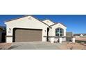 Inviting single-story home with a two-car garage and a well-manicured front yard at 25308 W Sunland Ave, Buckeye, AZ 85326