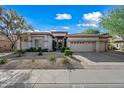 Inviting single-Gathering home boasts meticulous landscaping and a spacious driveway leading to a two-car garage at 4503 E Robin Ln, Phoenix, AZ 85050