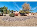 Spacious exterior view of landscaped front yard, colorful foliage, and a charming home exterior at 62 W Secretariat Dr, Tempe, AZ 85284
