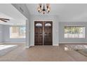 Inviting foyer featuring tiled flooring, light gray walls, and decorative double front doors at 62 W Secretariat Dr, Tempe, AZ 85284