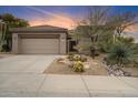 Charming home featuring a desert landscape and a two-car garage at 7111 E Sienna Bouquet Pl, Scottsdale, AZ 85266