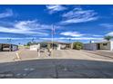 Well-maintained home featuring a wide driveway, covered parking, and low-maintenance yard at 7408 E Bosaga Way, Mesa, AZ 85208