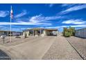 Inviting single-story home with easy-care landscaping, a convenient carport, and plenty of parking at 7408 E Bosaga Way, Mesa, AZ 85208