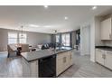 Open kitchen with modern stainless steel appliances, island with a sink, and an open view of the living space at 7552 W Darrel Rd, Laveen, AZ 85339