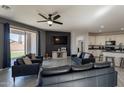 Spacious living room featuring an entertainment area, ceiling fan, and access to the kitchen at 7552 W Darrel Rd, Laveen, AZ 85339