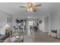 Bright living space open to the dining area, enhanced by hardwood floors and modern decor at 8064 E Madero Ave, Mesa, AZ 85209