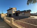 Two-story home featuring neutral siding, a fenced yard, and low-maintenance landscaping at 8154 W Greer Ave, Peoria, AZ 85345