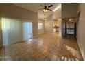 Bright living room features tile flooring, large windows, and access to the kitchen at 8154 W Greer Ave, Peoria, AZ 85345