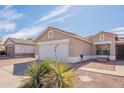 View of a single-story home, showcasing a spacious driveway, desert landscaping, and a welcoming facade at 8551 E Kiowa Ave, Mesa, AZ 85209