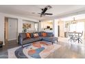 Open-concept living room with modern decor, a comfortable sofa, and seamless flow to the kitchen area at 8551 E Kiowa Ave, Mesa, AZ 85209