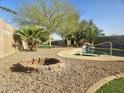 A backyard with a pool and spa, a fire pit, desert landscaping, and privacy walls at 8662 W Paradise Ln, Peoria, AZ 85382