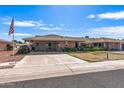 Lovely single-story home with a spacious driveway and well-maintained landscaping, adding to its curb appeal and charm at 10801 W Mountain View Rd, Sun City, AZ 85351