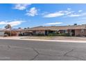 Beautifully landscaped single-story home with a well-manicured lawn and convenient carport in a desirable neighborhood at 10801 W Mountain View Rd, Sun City, AZ 85351