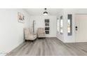 Bright living room featuring sleek laminate flooring, neutral tones, and modern furnishings at 12235 N 36Th Dr, Phoenix, AZ 85029