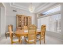 Elegant dining room featuring a wooden table, hutch, and chandelier at 14621 W Black Gold Ln, Sun City West, AZ 85375