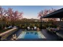 Backyard pool area featuring a fire pit, covered dining, lounge chairs and mountain views at 19355 N 73Rd Way # 4016, Scottsdale, AZ 85255