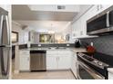 Modern kitchen with stainless steel appliances, granite countertops and white cabinets at 19777 N 76Th St # 1272, Scottsdale, AZ 85255