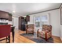 Comfortable living room area with hardwood floors, a dining table, and natural light at 201 S Greenfield Rd # 254, Mesa, AZ 85206