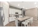 Modern kitchen with granite countertops, white cabinetry, a large center island, and stainless steel appliances at 21258 W Wilshire Dr, Buckeye, AZ 85396