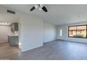 Open living space flows into a modern kitchen, with sleek flooring, updated fixtures, and ample natural light at 2440 N 22Nd Ave, Phoenix, AZ 85009