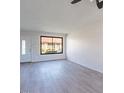 Bright living area with neutral walls, wood-look floors, and a window, freshly renovated at 2440 N 22Nd Ave, Phoenix, AZ 85009