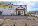 Inviting two-story home with a covered front porch, black trim, and drought-tolerant landscaping at 26217 N 19Th Ln, Phoenix, AZ 85085