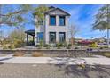 Beautiful two-story home featuring a well-manicured front yard, dark trim, and lovely landscaping at 26217 N 19Th Ln, Phoenix, AZ 85085