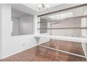 Open-concept dining area with wood floors and decorative wall mirror at 2875 W Highland St # 1102, Chandler, AZ 85224