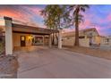 Charming single-story home with covered parking and a well-maintained yard at sunset at 2966 S Country Club Way, Tempe, AZ 85282