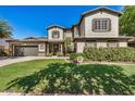 Charming two-story home featuring a well-manicured lawn and inviting front entrance with beautiful shutters at 3062 E Cullumber St, Gilbert, AZ 85234