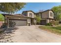 Traditional two-story home with attached two-car garage, manicured lawn, and mature trees at 3062 E Cullumber St, Gilbert, AZ 85234