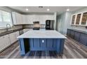 Modern kitchen features white cabinets, stainless steel appliances, and a large central island with a white countertop at 3062 E Cullumber St, Gilbert, AZ 85234