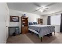 Simple bedroom with neutral colors, carpeted floors, and a ceiling fan at 3262 E Enid Ave, Mesa, AZ 85204