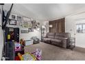 Comfortable living room with a sofa, eclectic decor, and carpeted flooring at 3262 E Enid Ave, Mesa, AZ 85204