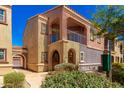 A beautiful two-story home with a private balcony, neutral stucco and covered entryway at 3935 E Rough Rider Rd # 1076, Phoenix, AZ 85050