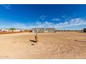 Expansive lot with a manufactured home in the distance, offering ample space for outdoor activities at 4111 N 313Th Ave, Buckeye, AZ 85396