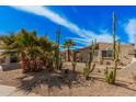 A single-story home with desert landscaping, and a quaint front entrance and window at 4116 N 105Th Ln, Phoenix, AZ 85037