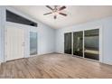 Bright and airy living room featuring tile flooring, a ceiling fan, and sliding door to the backyard at 4116 N 105Th Ln, Phoenix, AZ 85037