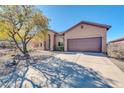 Exterior showcasing a two-car garage, desert landscaping, and a covered front entrance at 4365 S Columbine Way, Gold Canyon, AZ 85118