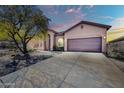 Exterior showcasing a two-car garage, desert landscaping, and a covered front entrance at 4365 S Columbine Way, Gold Canyon, AZ 85118